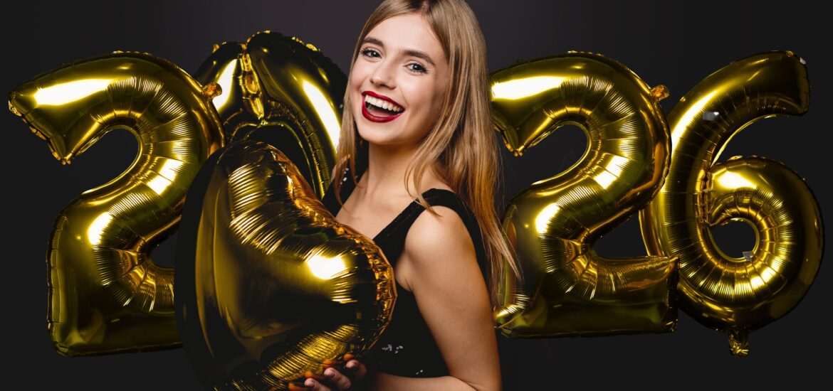 young woman smiling holding 2026 balloons, perfect white teeth