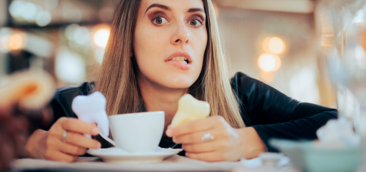 worried woman in a cafe, yellowing teeth