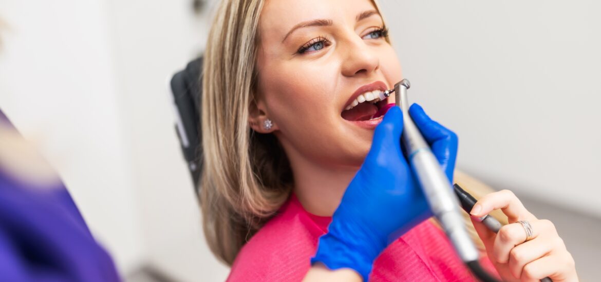 dentist polishing a female patients crown